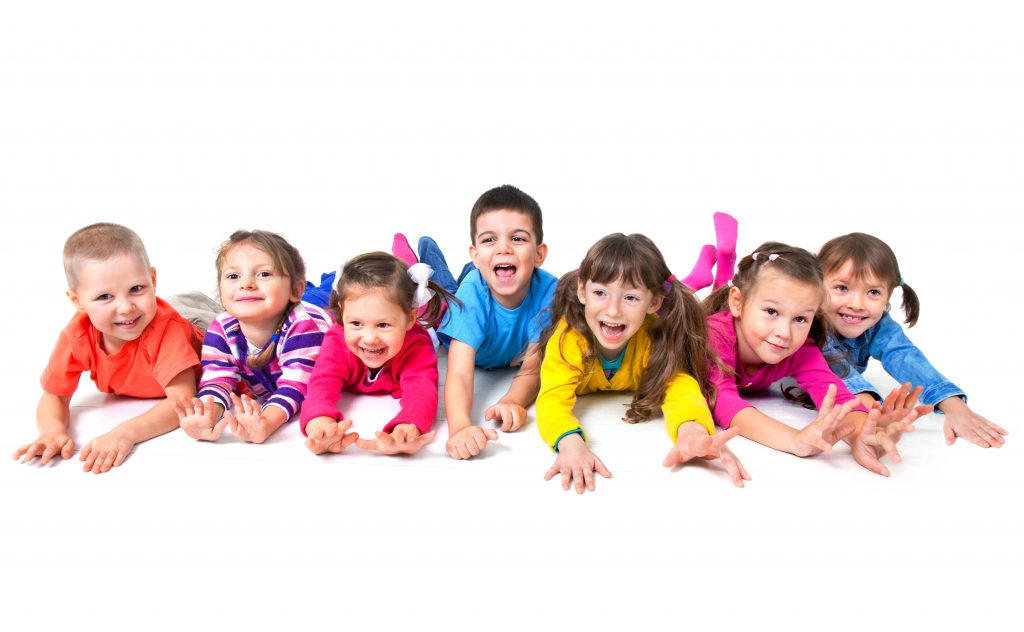 Group of seven  playful children are lying on floor  together
